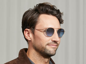 Model is wearing The KUGEL SUN in Cinnamon in size 49 with Denim Blue Tinted Lenses