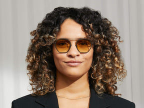 Model is wearing The KUGEL SUN in Pine in size 49 with Chestnut Fade Tinted Lenses