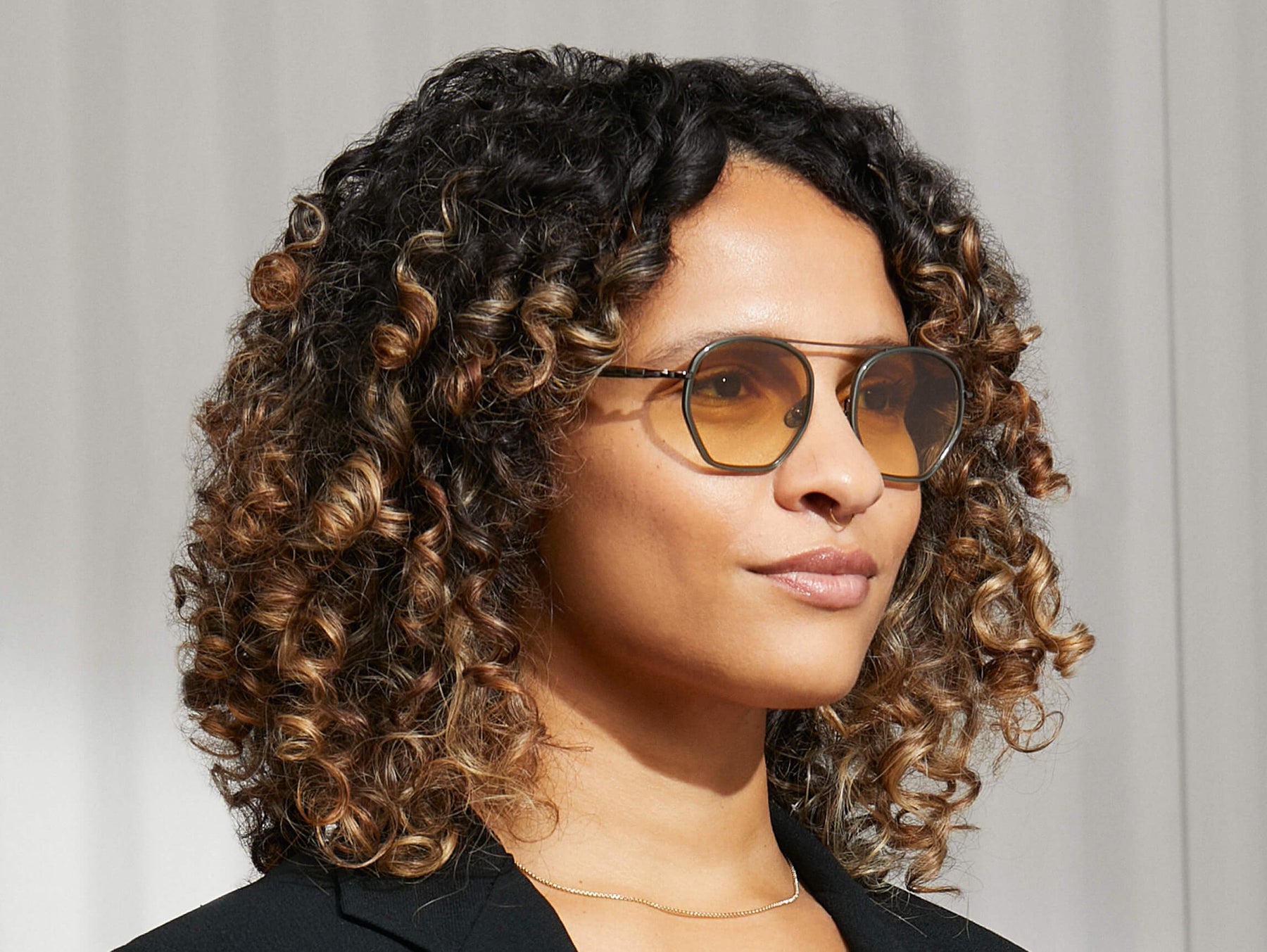 Model is wearing The KUGEL SUN in Pine in size 49 with Chestnut Fade Tinted Lenses