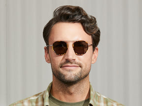 Model is wearing The KUGEL SUN in Tortoise in size 49 with G-15 Lenses