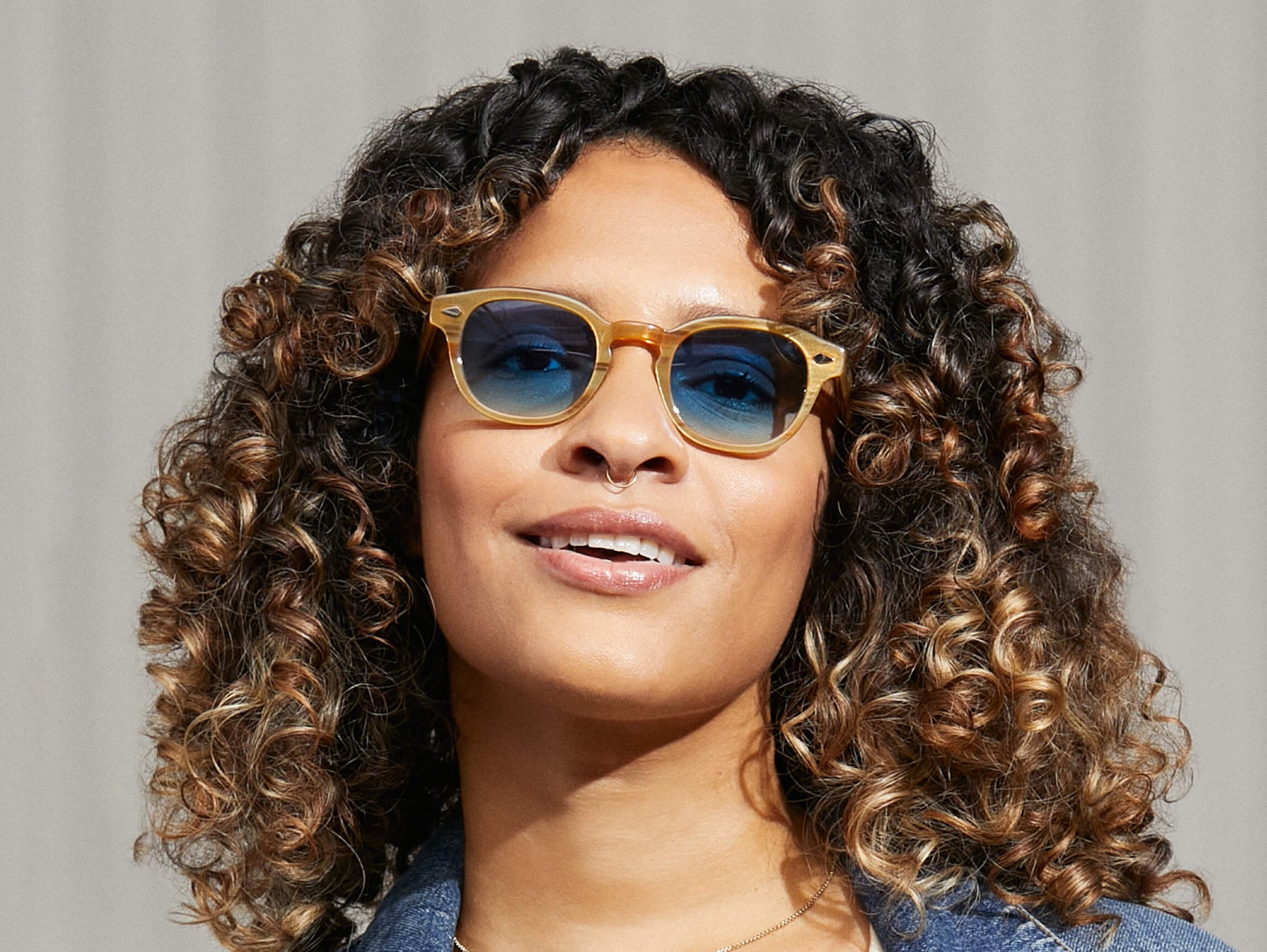 Model is wearing The LEMTOSH in Blonde in size 46 with Broadway Blue Fade Tinted Lenses