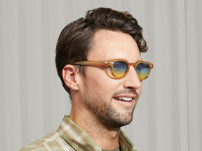 Model is wearing The LEMTOSH in Blonde in size 46 with Aqua Sunrise Tinted Lenses