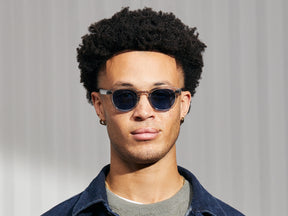 Model is wearing The LEMTOSH in Light Grey in size 46 with BLUE⁺ Tinted Lenses