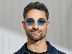 Model is wearing The LEMTOSH in Crystal in size 46 with Celebrity Blue Tinted Lenses