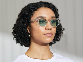 Model is wearing The LEMTOSH in Crystal in size 49 with Turquoise Tinted Lenses