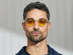 Model is wearing The LEMTOSH in Crystal in size 46 with Mellow Yellow Tinted Lenses