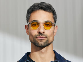 Model is wearing The LEMTOSH in Crystal in size 46 with Mellow Yellow Tinted Lenses