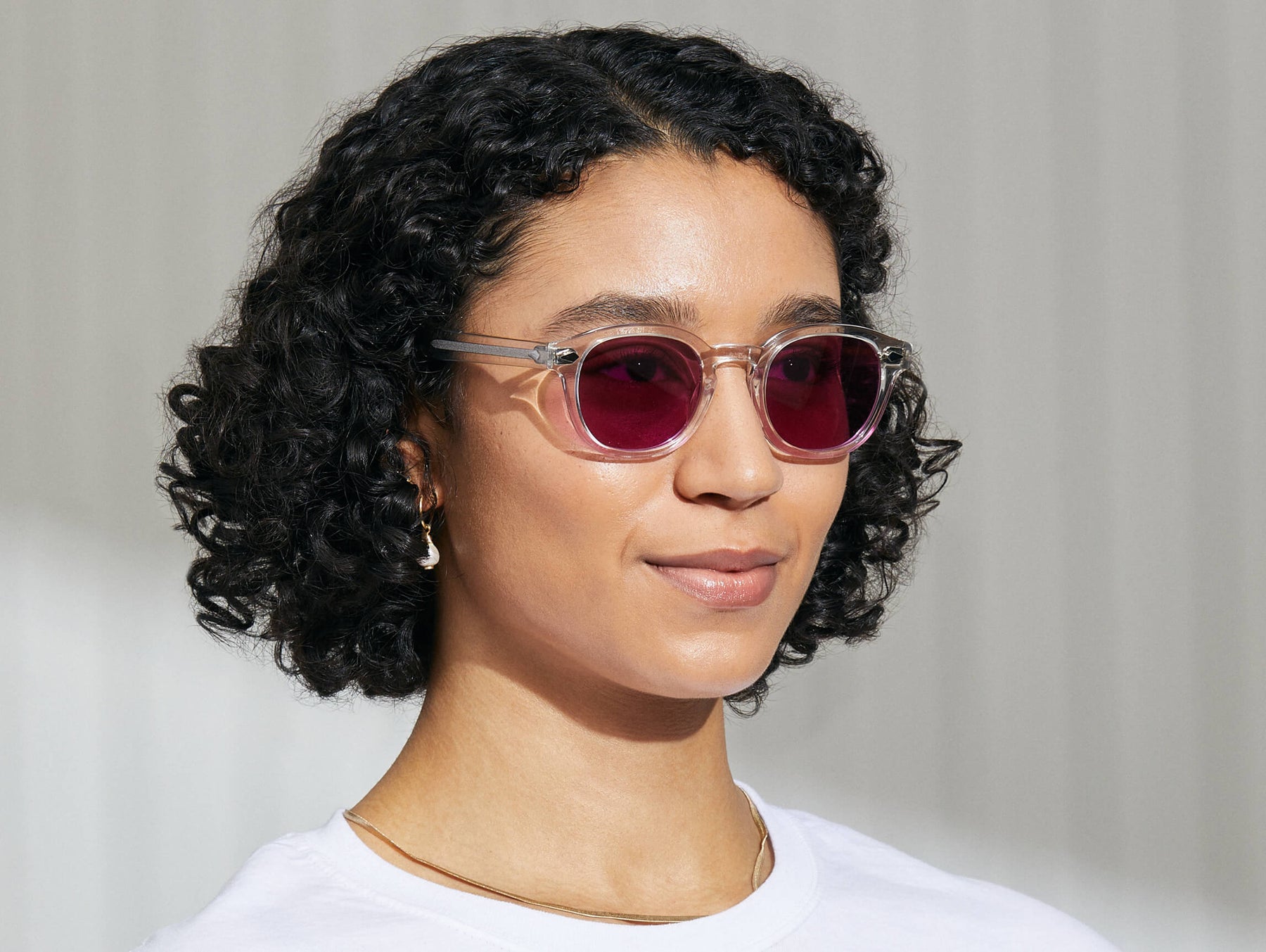 Model is wearing The LEMTOSH in Crystal in size 49 with Purple Nurple Tinted Lenses