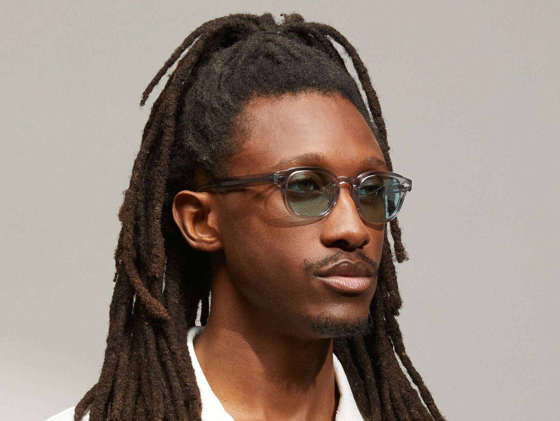 Model is wearing The LEMTOSH in Light Grey in size 46 with Turquoise Tinted Lenses