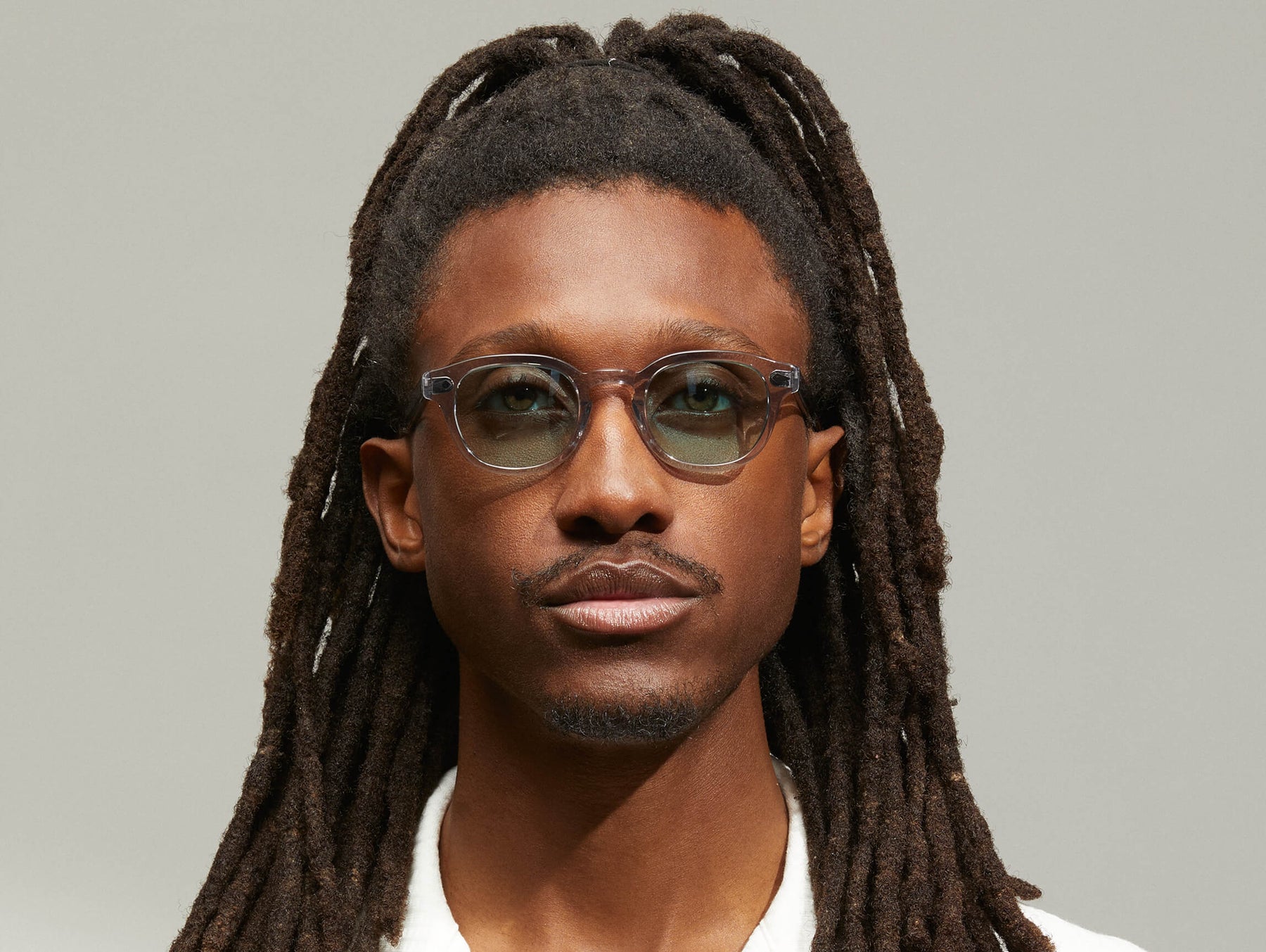 Model is wearing The LEMTOSH in Light Grey in size 46 with Turquoise Tinted Lenses