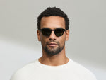 Model is wearing The LEMTOSH SUN in size 46 in Black with G-15 Glass Lenses