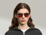 Model is wearing The LEMTOSH Brown Ash in size 49 with Cabernet Tinted Lenses