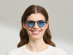 Model is wearing The LEMTOSH Sage in size 49 with Celebrity Blue Tinted Lenses