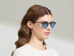 Model is wearing The LEMTOSH Sage in size 49 with Celebrity Blue Tinted Lenses