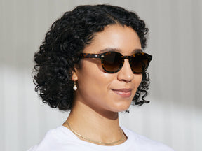 Model is wearing The LEMTOSH SPORT in Tortoise in size 49 with Amber Polarized Nylon Lenses