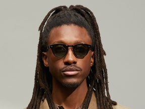 Model is wearing The LEMTOSH SUN with Metal Nose Pads in Black in size 46 with G-15 Glass Lenses