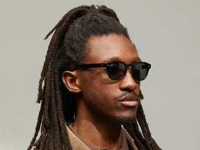 Model is wearing The LEMTOSH SUN with Metal Nose Pads in Black in size 46 with G-15 Glass Lenses