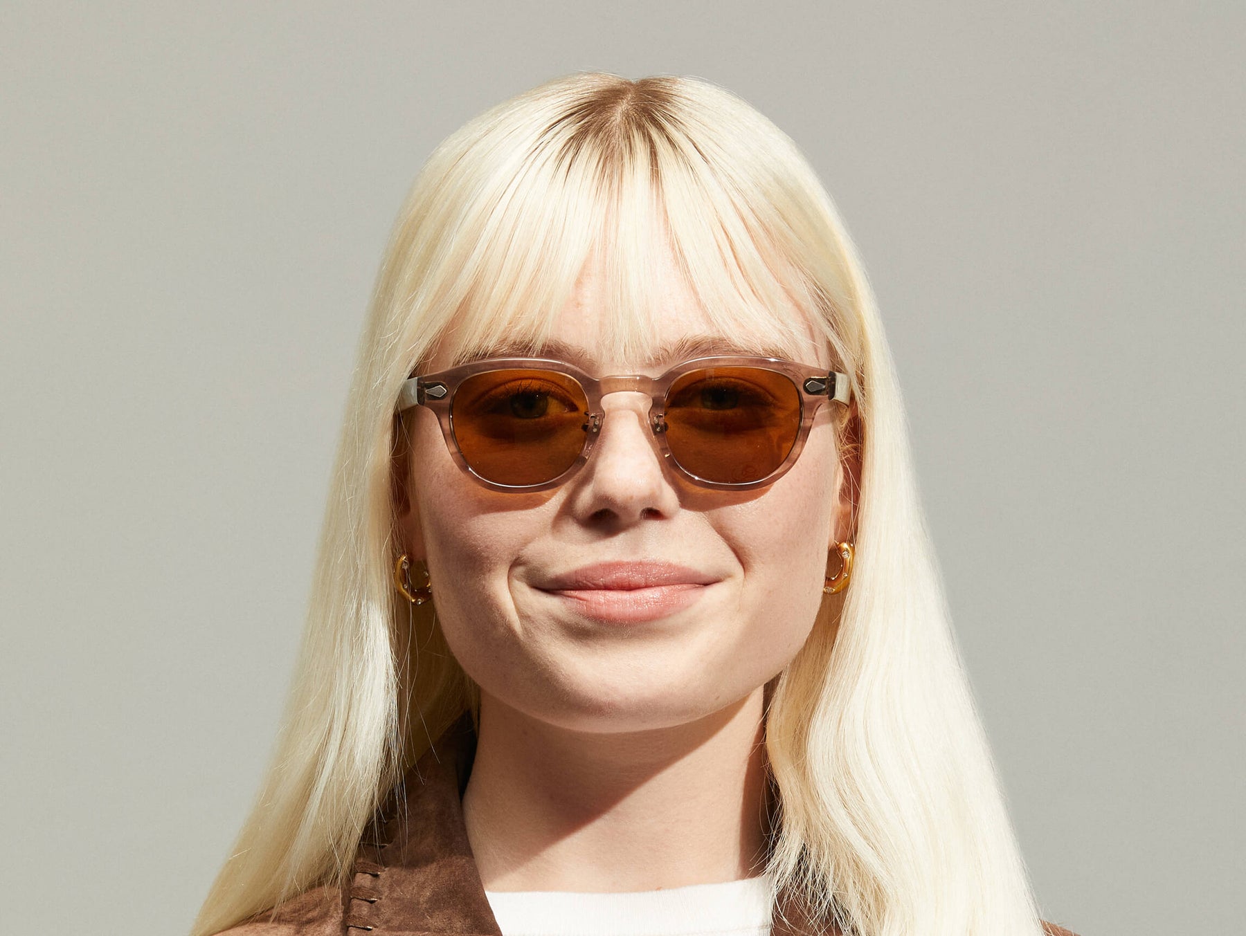 Model is wearing The LEMTOSH SUN with Metal Nose Pads in Brown Ash in size 46 with Cosmitan Brown Glass Lenses