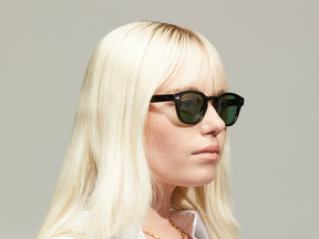 Model is wearing The LEMTOSH in Black size 46 with GREEN+ Tinted Lenses
