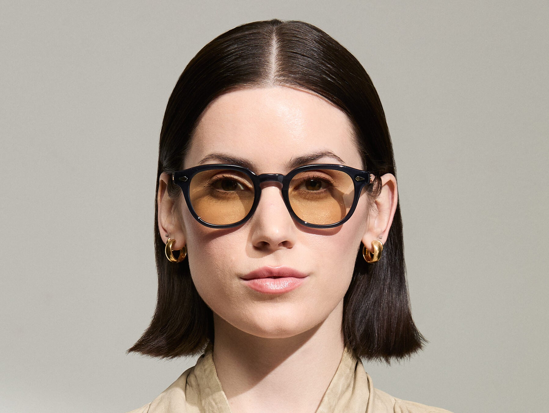 Model is wearing The LEMTOSH-TT 110 SUN in size 49 in Navy/Gold with BROWN+ Lenses