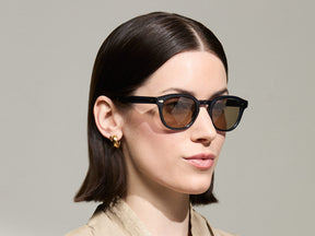 Model is wearing The LEMTOSH-TT 110 SUN in size 49 in Navy/Gold with BROWN+ Lenses