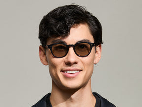 Model is wearing The LEMTOSH-TT 110 SUN in size 46 in Navy/Gold with BROWN+ Lenses