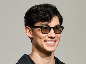 Model is wearing The LEMTOSH-TT 110 SUN in size 46 in Navy/Gold with BROWN+ Lenses