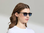 Model is wearing The LIKTIG SUN in size 53 in Black with Denim Blue Tinted Lenses
