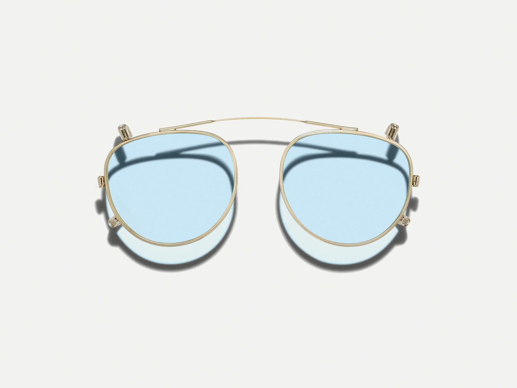 The MAYDELA CLIP in Gold with Bel Air Blue Tinted Lenses