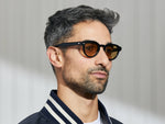 Model is wearing The MAYDELA SUN in Black in size 46 with Amber Tinted Lenses