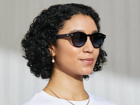 Model is wearing The MAYDELA SUN in Burgundy in size 49 with Denim Blue Tinted Lenses