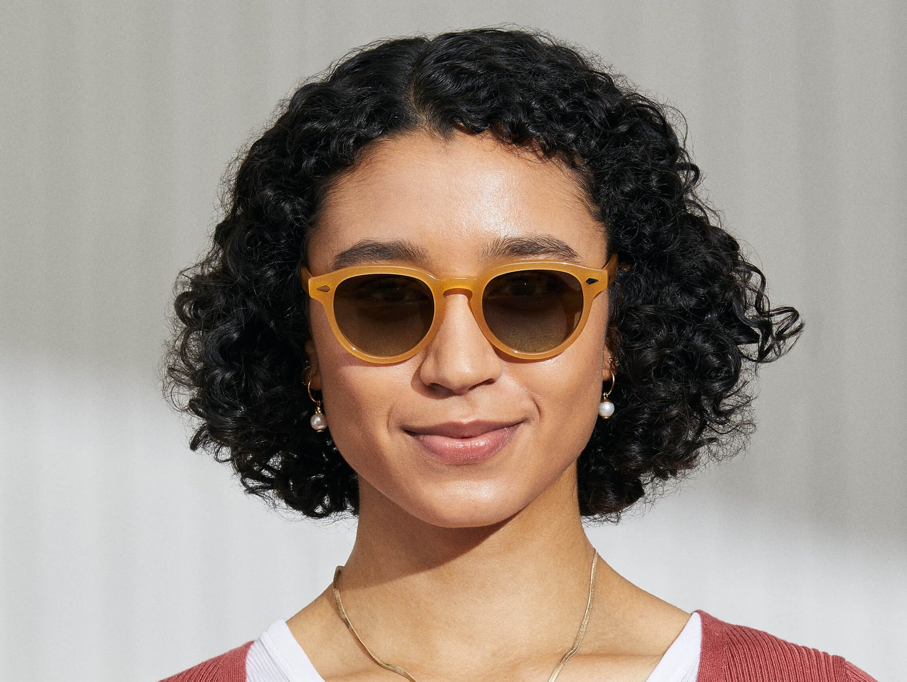 Model is wearing The MAYDELA SUN in Goldenrod in size 49 with Forest Wood Tinted Lenses