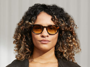 Model is wearing The MEKLER SUN in Classic Havana in size 49 with Chestnut Fade Tinted Lenses