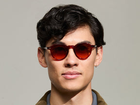 Model is wearing The MILTZEN in Ruby in size 46 with Cabernet Tinted Lenses