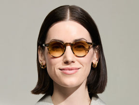 Model is wearing The MILTZEN in Bamboo in size 46 with Chestnut Fade Tinted Lenses