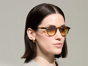 Model is wearing The MILTZEN in Bamboo in size 46 with Chestnut Fade Tinted Lenses
