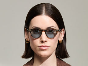Model is wearing The MILTZEN in Bark in size 46 with Mineral Blue Tinted Lenses