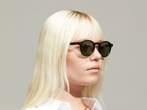 Model is wearing The MILTZEN SUN W/ METAL NOSE PADS in Black in size 46 with G-15 Glass Lenses
