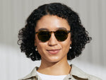 Model is wearing The MILTZEN SUN in Bamboo in size 49 with Calibar Green Glass Lenses