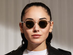 Model is wearing The MILTZEN SUN in Crystal in size 44 with G-15 Glass Lenses