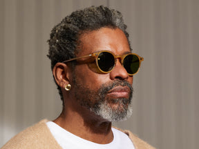 Model is wearing The MILTZEN SUN in Blonde in size 49 with Calibar Green Glass Lenses