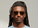 Model is wearing The MIZER SUN in size 54 in Dark Green with G-15 Tinted Lenses