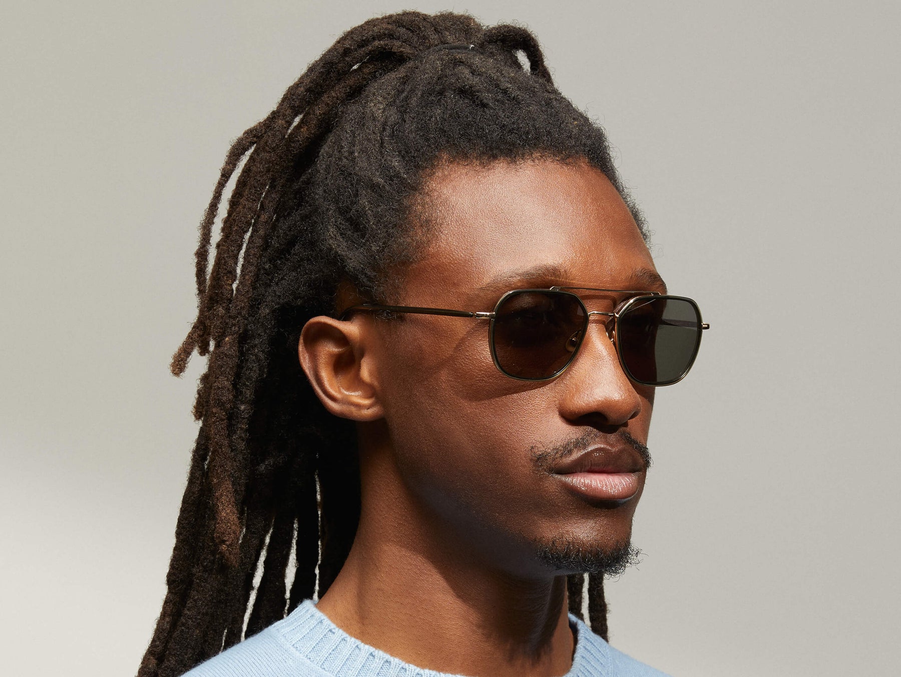 Model is wearing The MIZER SUN in size 54 in Dark Green with G-15 Tinted Lenses