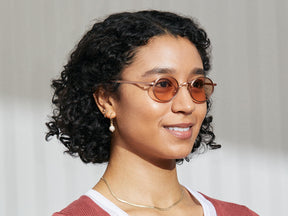 Model is wearing The MOYEL SUN in Rose in size 44 with New York Rose Tinted Lenses