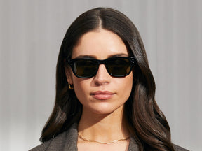 Model is wearing The NEBB SUN in Black in size 51 with G-15 Glass Lenses