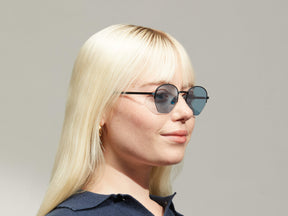 Model is wearing The PLOTZ SUN in size 49 in Navy with Blue Tinted Lenses
