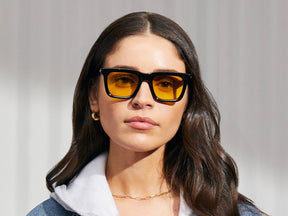 Model is wearing The RIZIK in Black in size 49 with Mellow Yellow Tinted Lenses