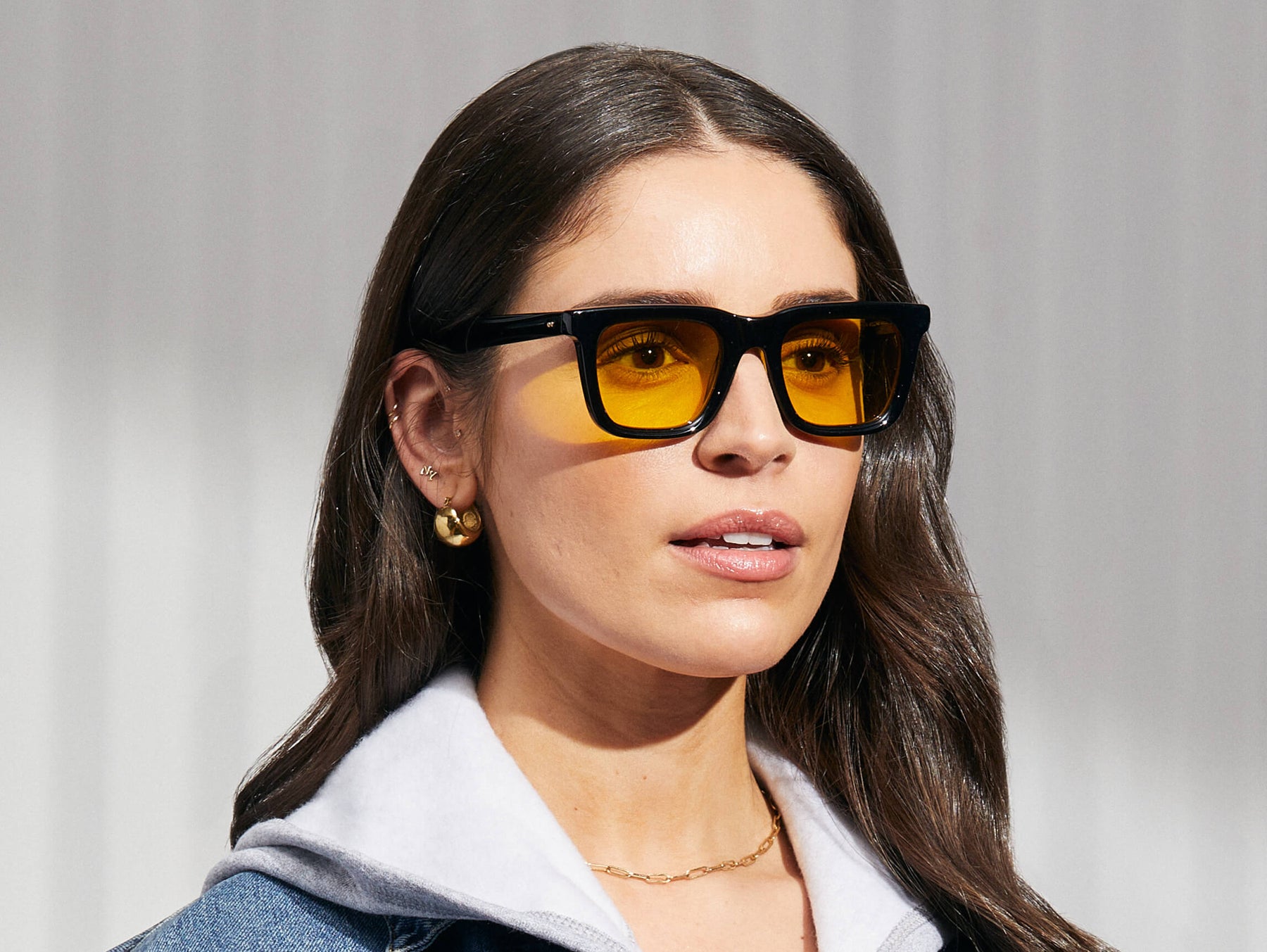 Model is wearing The RIZIK in Black in size 49 with Mellow Yellow Tinted Lenses