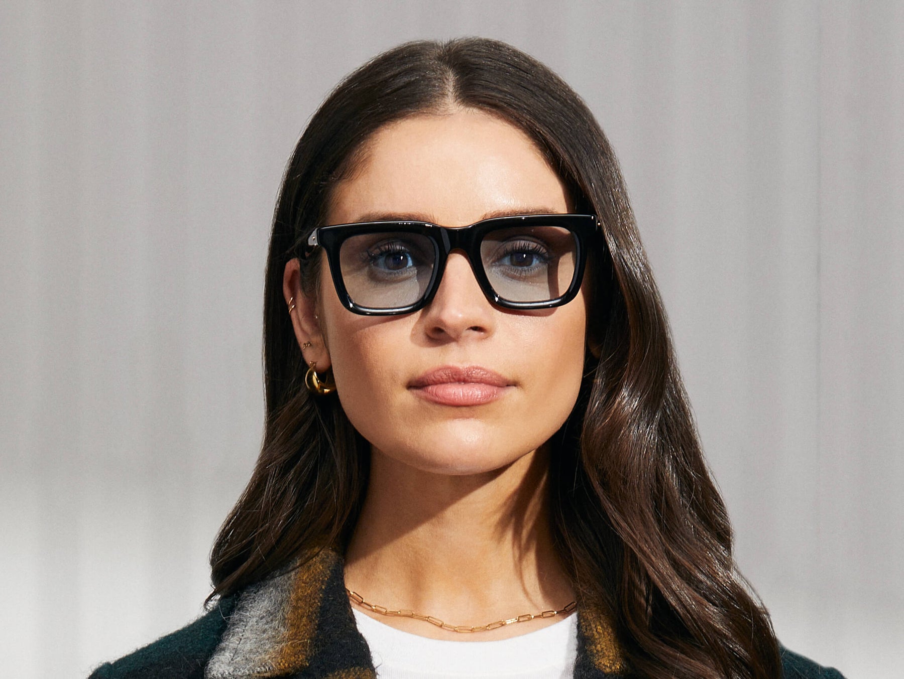 Model is wearing The RIZIK in Black in size 49 with Bel Air Blue Tinted Lenses