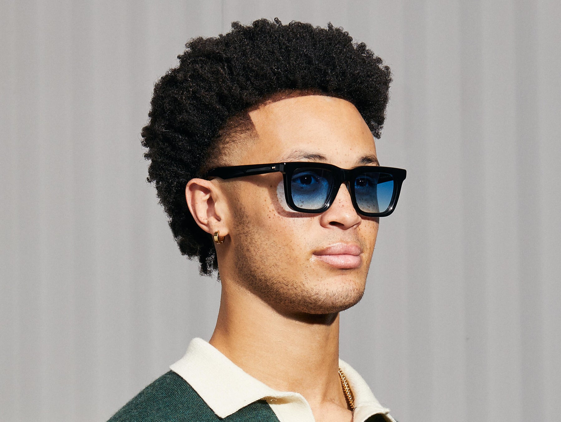 Model is wearing The RIZIK in Black in size 49 with Broadway Blue Fade Tinted Lenses